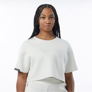 Alphalete ELMTS half sleeve pullover cream workout crop top